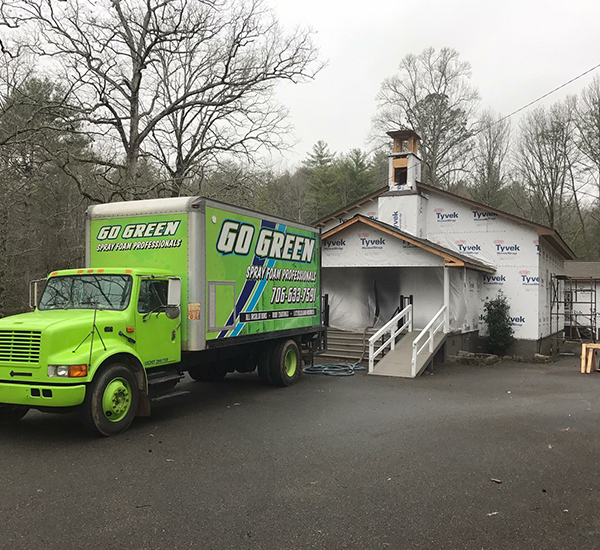 Go Green Spray Foam Professionals installing eco-friendly insulation to reduce energy costs.