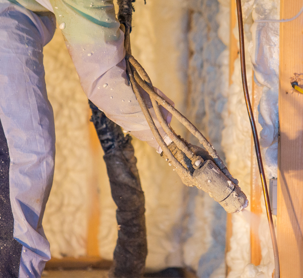 Fiberglass insulation installation by Go Green Spray Foam Professionals for energy efficiency.